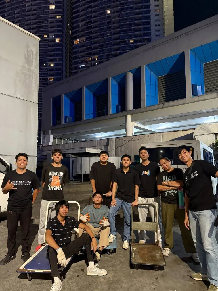 Events Rental Hub crew posing at night with equipment carts after an on-site event setup