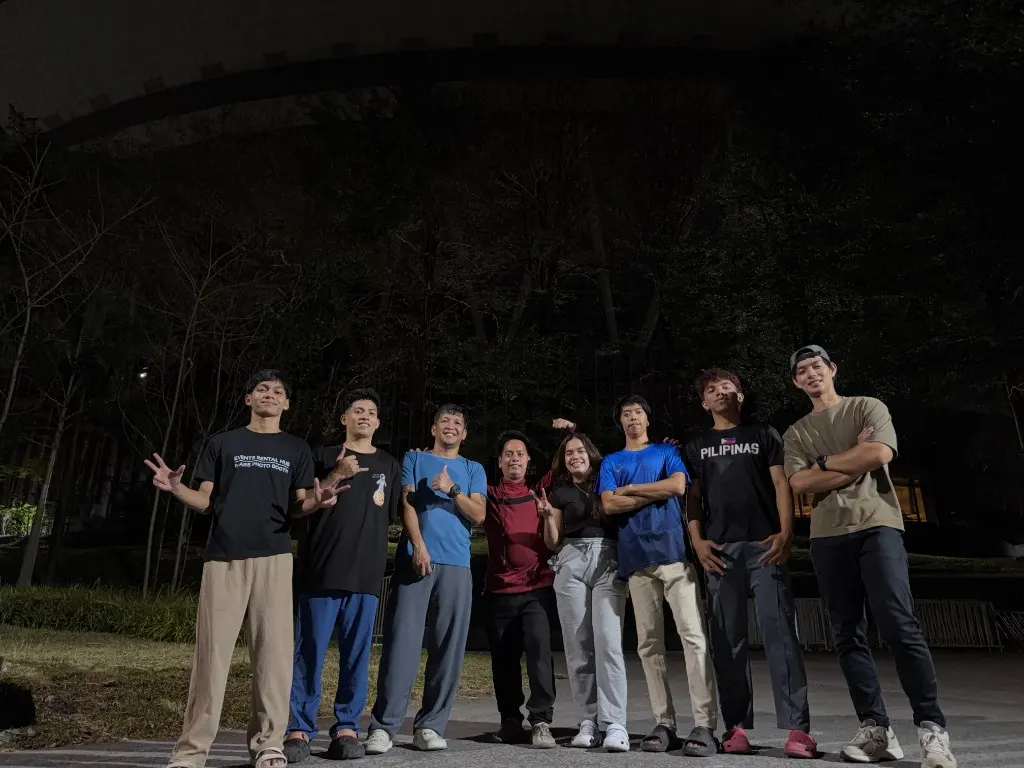 Events Rental Hub team posing outdoors at night in branded work shirts